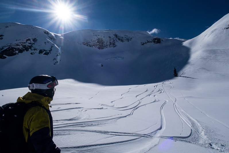 Deep dry winter powder snow preserved inside the mountain shade lines on a north facing aspect