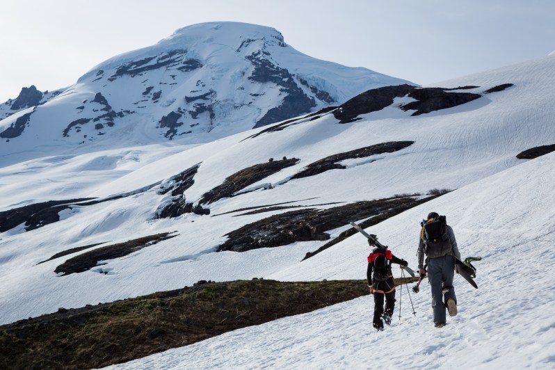 A skier and a splitboarder heading up towards Mount Baker in June