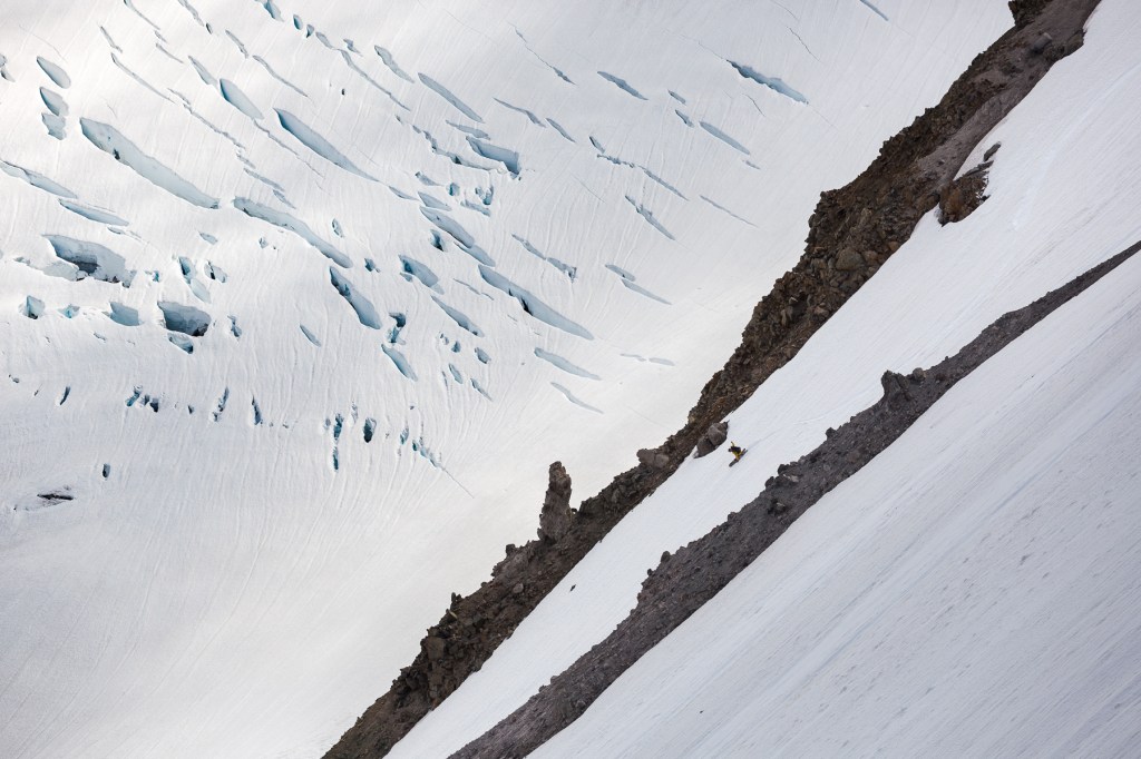 Tomoki carving a splitboard turn with his gentemstick board through spring corn snow on the lower slopes of the Inter Glacier